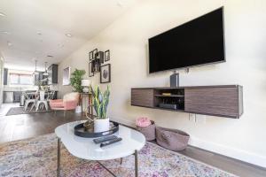 a living room with a flat screen tv on a wall at San Mateo 2br w parking ac nr shops parks SFO-1555 in San Mateo