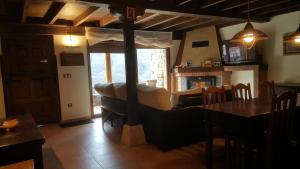 a room with a bed and a dining room with a table at Casa la Felguerina in La Felguerina