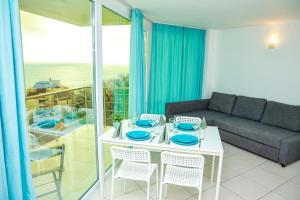 a living room with a white table and a couch at Апартаменти Дача in Varna City