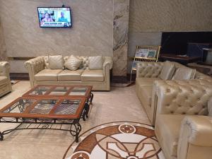 a living room with couches and a table at Hotel Benzz Park Chennai in Chennai