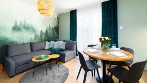 uma sala de estar com um sofá e uma mesa em Apartament Leśny Karpacz em Karpacz