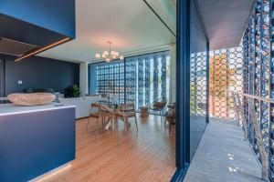 a kitchen and living room with blue walls and wood floors at New Luxury Central Cascais in Cascais