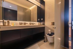 a bathroom with a toilet and a large mirror at New Luxury Central Cascais in Cascais +16 photos
