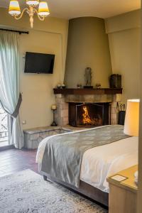 a bedroom with a bed and a fireplace at MARON ΙΙ με τζάκι in Kalavrita