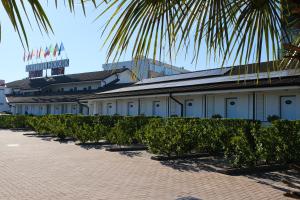 a building with a palm tree in front of it at Hotel Motel 2000 in Trezzano sul Naviglio