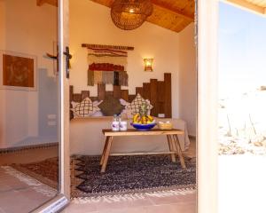 a room with a table with a bowl of fruit on it at Dakhla Attitude in Dakhla