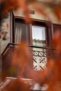 a window of a house with a balcony at MARON ΙΙ με τζάκι in Kalavrita +27 photos
