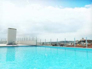 a large swimming pool on top of a building at Modern Apartment * 2 Bedrooms * Pool in São Martinho do Porto