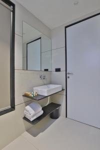 a bathroom with a sink and a mirror at Hotel Elements Surat in Surat