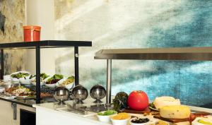 a buffet line with appetizers and plates of food at Mövenpick Hotel Gammarth Tunis in Gammarth