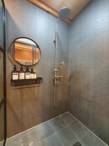 a bathroom with a shower and a mirror at Haenggung stay Dalno - Suwon private house hanok in Suwon