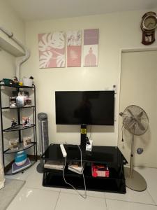 a living room with a flat screen tv on a wall at 2BR Condo Unit at Prisma Residences in Manila