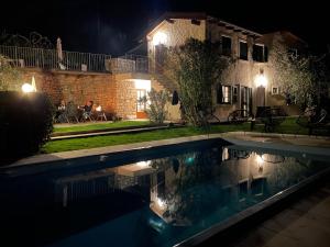 a house with a swimming pool at night at Villa Fuzzys - Un antico casale ristrutturato in Malcesine