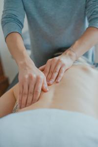 a woman is getting a massage on her stomach at Delightful Shepherd hut in Graffham