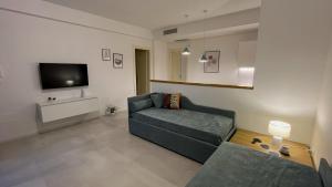 a living room with a couch and a tv at Corte Cesarina in Porto Cesareo