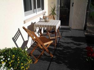 une table et des chaises assises sur une terrasse dans l'établissement Ferienwohnung Ehret, à Wald-Michelbach
