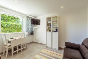 a living room with a couch and a table and a window at Algés Village Casa 2 by Lisbon-Coast vacation in Algés
