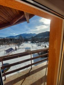 a view of a snow covered field from a window at Casa Tamara in Bran