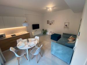 ein Wohnzimmer mit einem Tisch, Stühlen und einem Sofa in der Unterkunft Corte Cesarina in Porto Cesareo