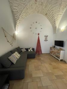 a living room with a couch and a clock on the wall at La Terrazza del Marinaio in Ostuni