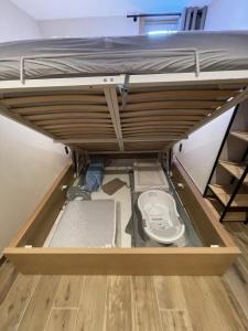 a loft bed with the bottom drawer open at LE REFUGE LES 2 ALPES 1800 in Les Deux Alpes