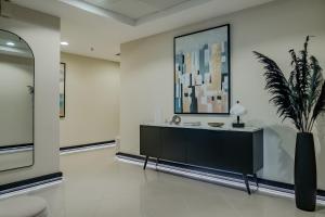 a room with a black cabinet and a potted plant at Clever Guest Concorde JLT in Dubai