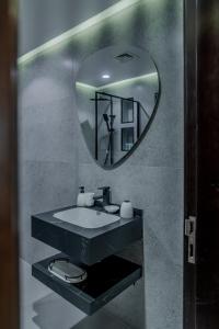 a bathroom with a sink and a mirror at Clever Guest Concorde JLT in Dubai