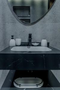 a bathroom with a sink and a mirror at Clever Guest Concorde JLT in Dubai