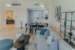 a living room with a couch and a table at Clever Guest Concorde JLT in Dubai