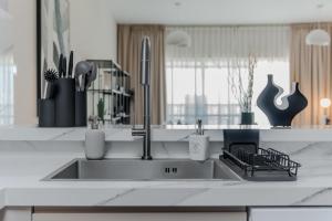 a kitchen with a sink and a counter top at Clever Guest Concorde JLT in Dubai