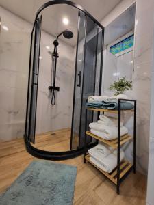 a bathroom with a shower and a rack with towels at ToP center of Varna in Varna City +53 photos