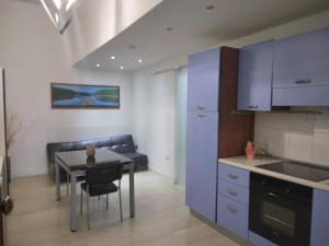 a kitchen and living room with a table and a couch at Bunker degli inventori in Foggia