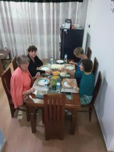 a group of women sitting around a wooden table at Hansa Villa in Kandy