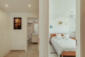 a bedroom with a bed and a bathroom at Algés Village Casa 2 by Lisbon-Coast vacation in Algés
