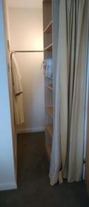 a closet with a refrigerator and a curtain at Aquila Retreats in Comrie