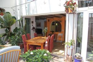 a patio with a wooden table and chairs at Bed & Breakfast Wepfer in Grüt