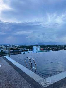 a swimming pool on the roof of a building at Kozi Square Dual Unit (1 bedroom, 1 living room) in Kuching