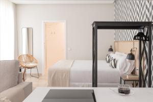 Ένα ή περισσότερα κρεβάτια σε δωμάτιο στο Hommyhome Vera-Cruz 1900