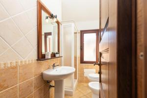 a bathroom with a sink and a toilet at ByNos Pool - Primo Piano in Santa Maria Navarrese +42 photos