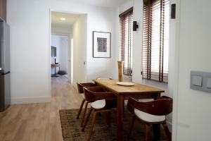 a dining room with a wooden table and chairs at Diaphanous and modern- 2Bd 2Bth- Plaza España in Madrid