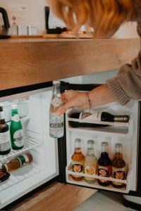 a person is reaching into an open refrigerator at Uitgerust voor Zaken in Heerenveen +47 photos