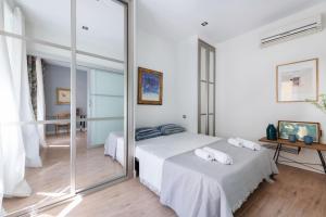 a bedroom with two beds and a large mirror at 1 bedroom 1 bathroom furnished - Sol - Downtown - Minty Stay in Madrid