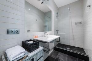 a white bathroom with a sink and a mirror at 1 bedroom 1 bathroom furnished - Sol - Downtown - Minty Stay in Madrid