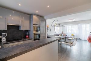 a kitchen with stainless steel appliances and a dining room at Bel appartement 3P Croisette*Cannes in Cannes