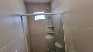 a bathroom with a shower with a glass door at Casa PraiAmar Atalaia in Salinópolis