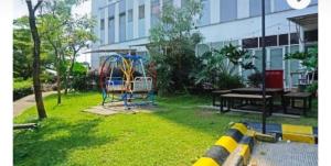 a playground in a yard next to a building at Sansan Room - Apartemen Gunung Putri Square in Parungdengdek