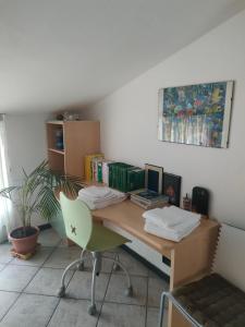 Habitación con escritorio con silla y libros. en Ca Bilofer Airport Apartment en Seriate