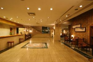 a lobby of a hotel with a rug on the floor at Hotel Danrokan in Kofu
