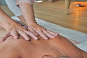 a person getting a massage on a mans knee at Beautiful Yurt with stunning South Downs views in Graffham