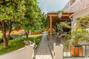 a street with trees and a fence and a building at Algés Village Casa 2 by Lisbon-Coast vacation in Algés